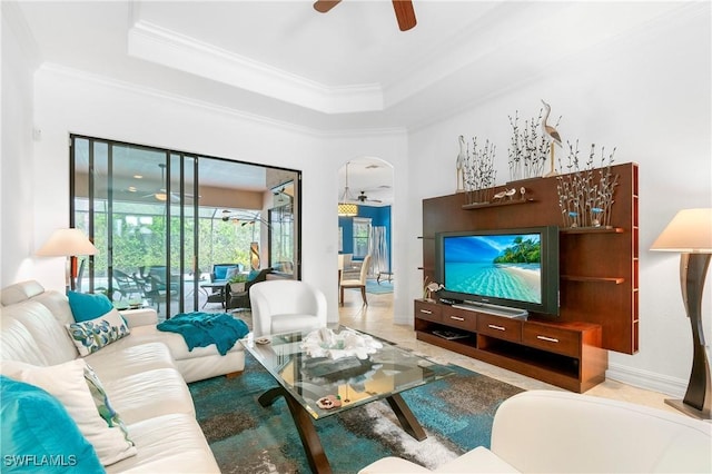 10986 Longwing Dr, Fort Myers, FL 33912 - living room featuring ceiling fan, ornamental molding, arched walkways, and a tray ceiling