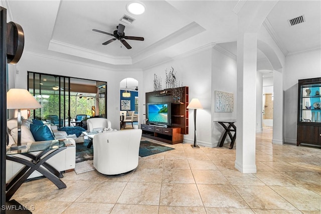10986 Longwing Dr, Fort Myers, FL 33912 - tiled living area featuring ceiling fan, ornamental molding, arched walkways, baseboards, and a tray ceiling