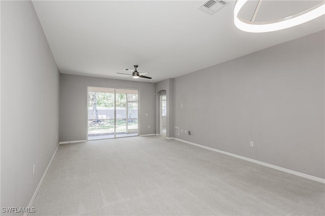 14183 Fall Creek Ct, Naples, FL 34114 - spare room featuring ceiling fan, baseboards, light carpet, and arched walkways