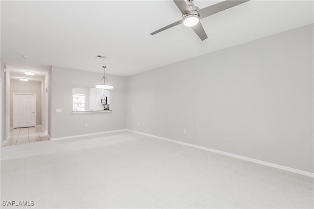 14183 Fall Creek Ct, Naples, FL 34114 - empty room featuring light carpet, baseboards, and ceiling fan