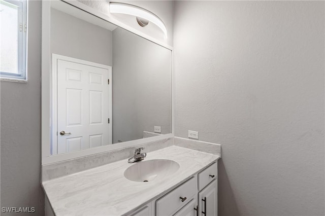 14183 Fall Creek Ct, Naples, FL 34114 - bathroom featuring vanity and a textured wall