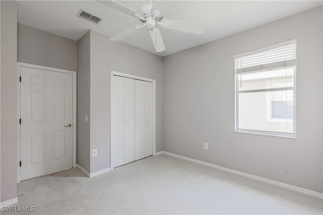 14183 Fall Creek Ct, Naples, FL 34114 - unfurnished bedroom with light colored carpet, baseboards, a closet, and a ceiling fan