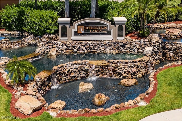 14183 Fall Creek Ct, Naples, FL 34114 - community / neighborhood sign featuring a garden pond