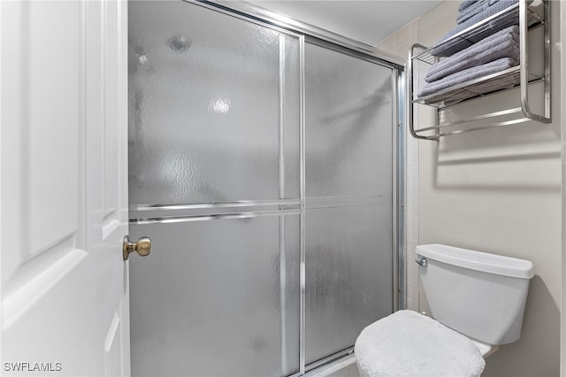 3001 Sandpiper Bay Cir Unit B103, Naples, FL 34112 - bathroom featuring a stall shower and toilet