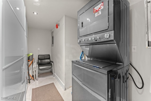 3001 Sandpiper Bay Cir Unit B103, Naples, FL 34112 - clothes washing area featuring stacked washer / drying machine, light tile patterned floors, baseboards, and recessed lighting