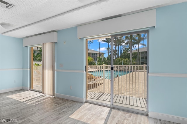 3001 Sandpiper Bay Cir Unit B103, Naples, FL 34112 - empty room featuring wood finished floors and baseboards
