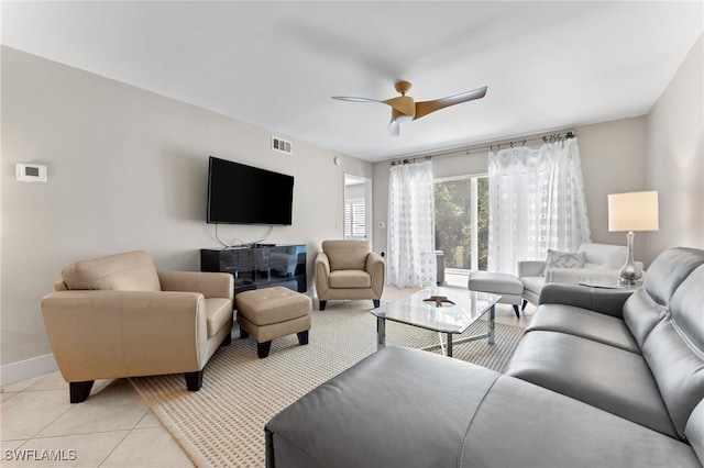 3001 Sandpiper Bay Cir Unit B103, Naples, FL 34112 - living room featuring baseboards, light tile patterned floors, and a ceiling fan