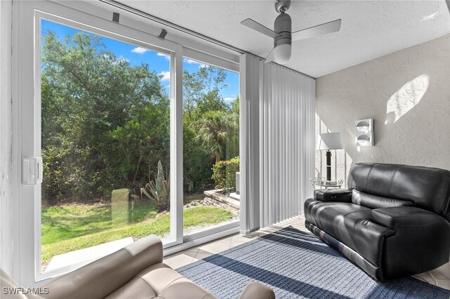 3001 Sandpiper Bay Cir Unit B103, Naples, FL 34112 - living area with a textured wall, a ceiling fan, tile patterned flooring, and a textured ceiling