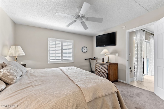3001 Sandpiper Bay Cir Unit B103, Naples, FL 34112 - bedroom with carpet, a ceiling fan, a textured ceiling, and tile patterned floors
