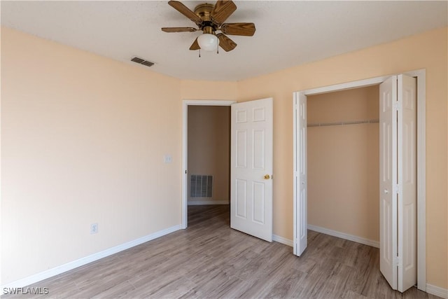 2022 Hunters Trace Cir, Middleburg, FL 32068 - unfurnished bedroom with light wood finished floors, a closet, baseboards, and ceiling fan