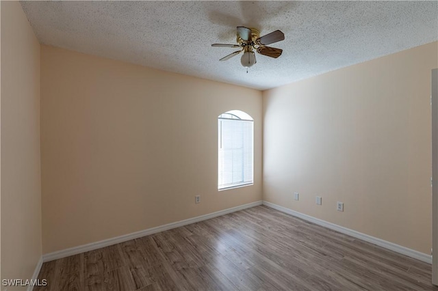 2022 Hunters Trace Cir, Middleburg, FL 32068 - unfurnished room featuring wood finished floors, ceiling fan, a textured ceiling, and baseboards