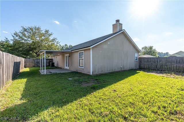 2022 Hunters Trace Cir, Middleburg, FL 32068 - rear view of house with a patio and a chimney