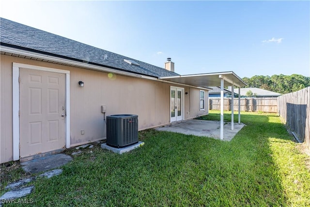 2022 Hunters Trace Cir, Middleburg, FL 32068 - rear view of house featuring french doors, central AC, roof with shingles, a patio, and a chimney