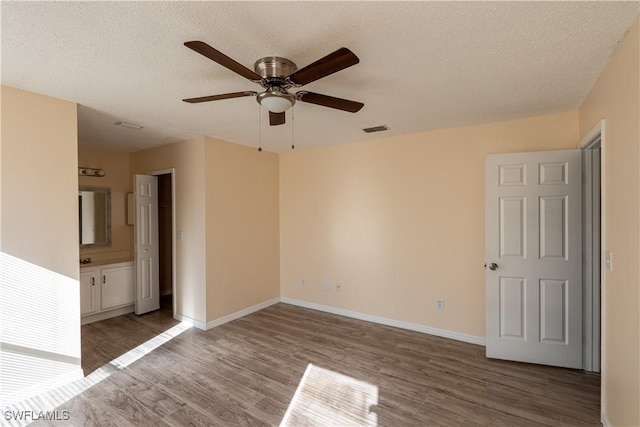 2022 Hunters Trace Cir, Middleburg, FL 32068 - unfurnished room with wood finished floors, ceiling fan, baseboards, and a textured ceiling