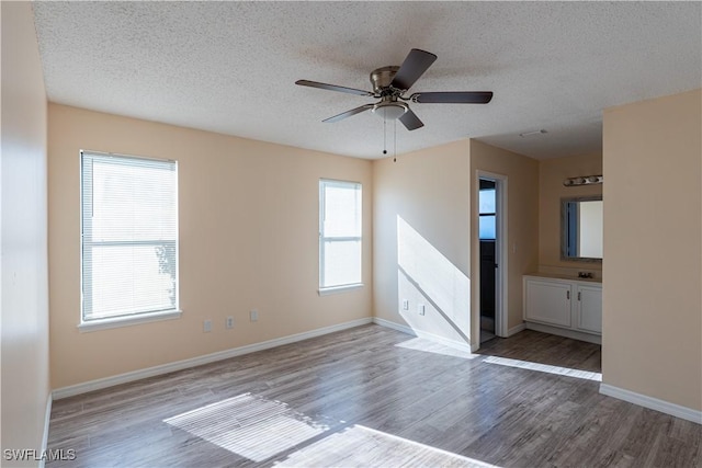2022 Hunters Trace Cir, Middleburg, FL 32068 - unfurnished room with wood finished floors, healthy amount of natural light, ceiling fan, and a textured ceiling