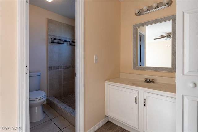 2022 Hunters Trace Cir, Middleburg, FL 32068 - full bath with toilet, vanity, tile patterned floors, a tile shower, and baseboards