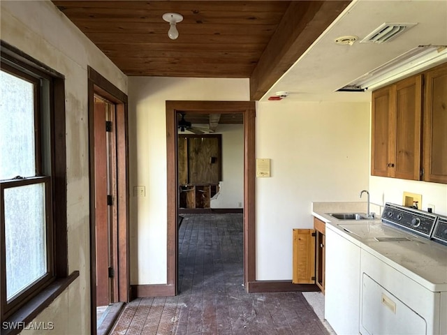 310 Pieces Of Eight, Captiva, FL 33924 - washroom featuring cabinet space, independent washer and dryer, wooden ceiling, dark wood-style flooring, and baseboards