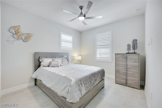 303 Indies Dr W Unit 201, Naples, FL 34114 - bedroom with baseboards, a ceiling fan, and light tile patterned floors