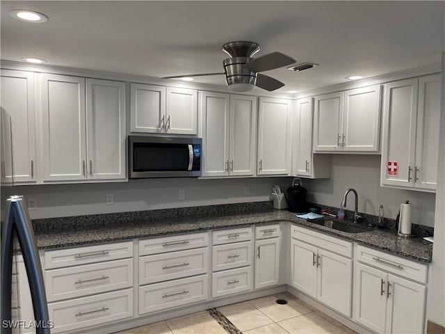 6184 Michelle Way Unit 123, Fort Myers, FL 33919 - kitchen featuring stainless steel microwave, a sink, light tile patterned floors, a ceiling fan, and dark stone countertops
