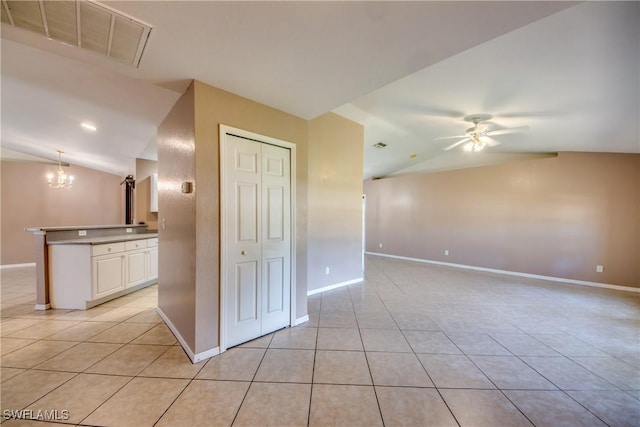 1601 SW 19th St, Cape Coral, FL 33991 - spare room with vaulted ceiling, light tile patterned flooring, a chandelier, a ceiling fan, and baseboards