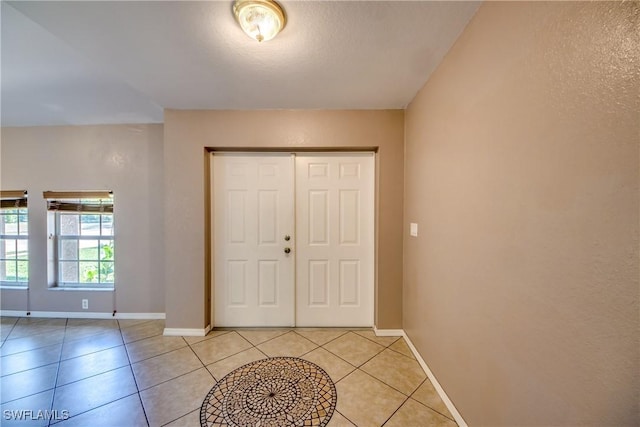 1601 SW 19th St, Cape Coral, FL 33991 - foyer featuring baseboards and light tile patterned floors