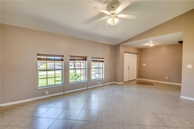 1601 SW 19th St, Cape Coral, FL 33991 - empty room with vaulted ceiling, ceiling fan, light tile patterned floors, and baseboards
