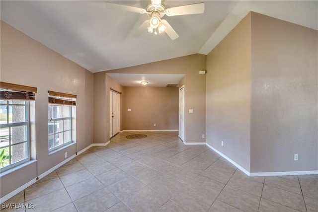 1601 SW 19th St, Cape Coral, FL 33991 - empty room featuring vaulted ceiling, light tile patterned flooring, a ceiling fan, and baseboards