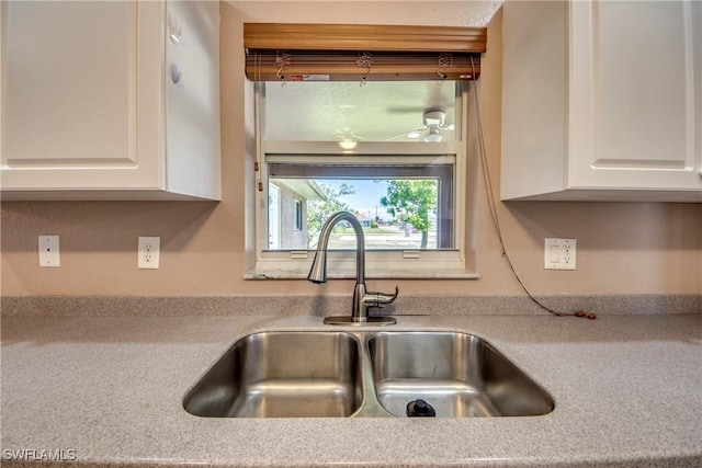 1601 SW 19th St, Cape Coral, FL 33991 - kitchen with a sink, white cabinetry, ceiling fan, and light countertops