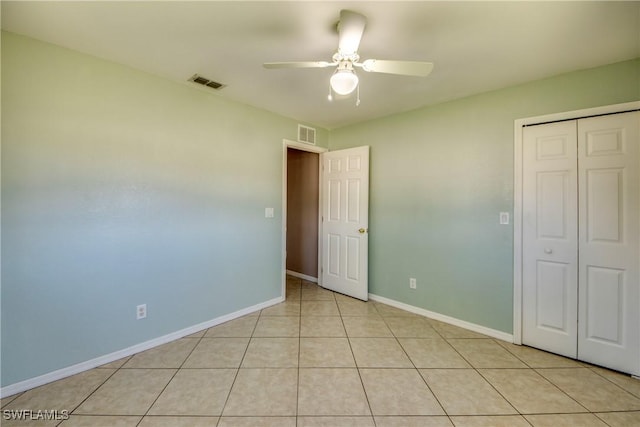 1601 SW 19th St, Cape Coral, FL 33991 - unfurnished bedroom featuring a closet, baseboards, light tile patterned flooring, and ceiling fan