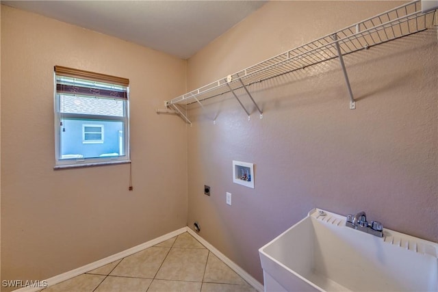 1601 SW 19th St, Cape Coral, FL 33991 - laundry area featuring hookup for a washing machine, light tile patterned flooring, hookup for an electric dryer, and baseboards