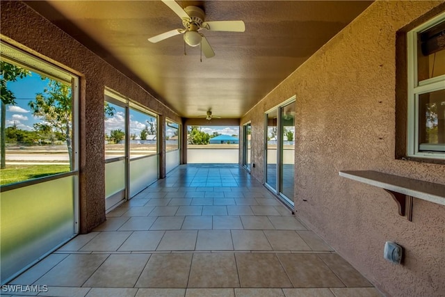 1601 SW 19th St, Cape Coral, FL 33991 - unfurnished sunroom with a ceiling fan, healthy amount of natural light, and a textured wall