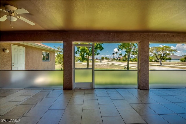 1601 SW 19th St, Cape Coral, FL 33991 - doorway to outside with a ceiling fan, a textured ceiling, and tile patterned floors