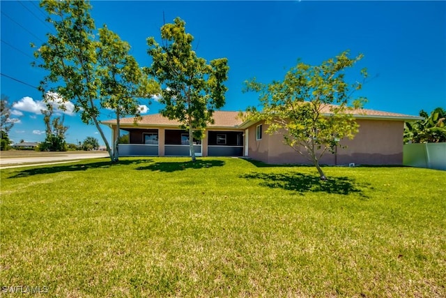 1601 SW 19th St, Cape Coral, FL 33991 - rear view of house featuring a lawn and stucco siding