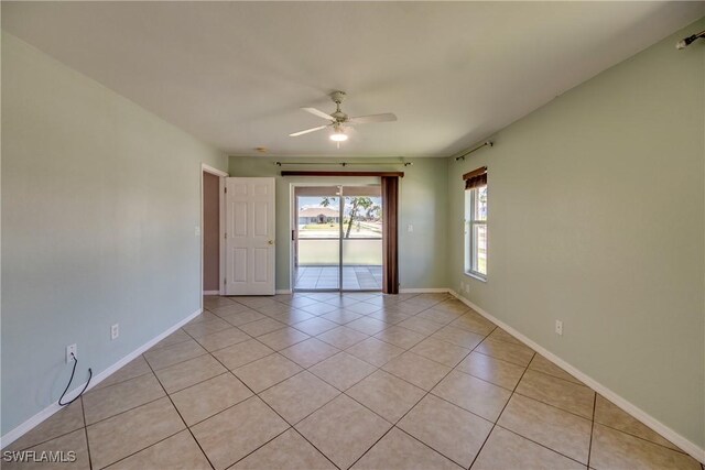 1601 SW 19th St, Cape Coral, FL 33991 - empty room with light tile patterned floors, ceiling fan, and baseboards