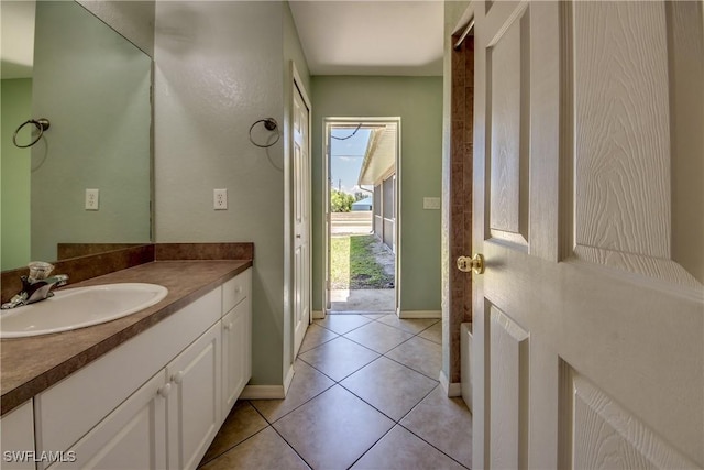 1601 SW 19th St, Cape Coral, FL 33991 - bathroom featuring baseboards, vanity, and tile patterned floors
