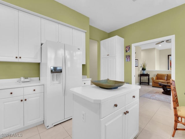 650 Vintage Reserve Cir Unit 5C, Naples, FL 34119 - kitchen featuring white refrigerator with ice dispenser, light countertops, white cabinetry, and a center island