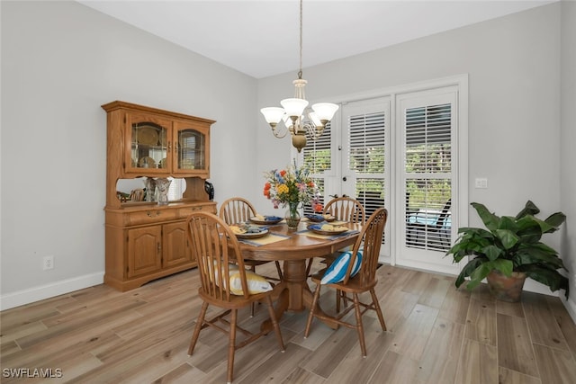 28996 Seton Ct, Bonita Springs, FL 34134 - dining space featuring a chandelier, light wood-type flooring, and baseboards