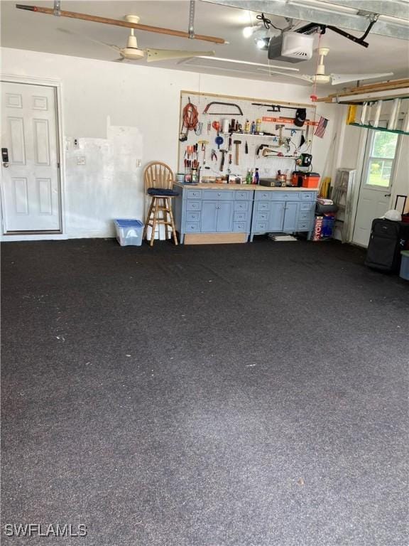 28996 Seton Ct, Bonita Springs, FL 34134 - garage with a workshop area and a garage door opener