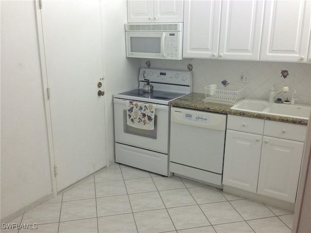 3760 Inverrary Dr Unit 1W, Lauderhill, FL 33319 - kitchen with white appliances, a sink, white cabinetry, light tile patterned floors, and decorative backsplash