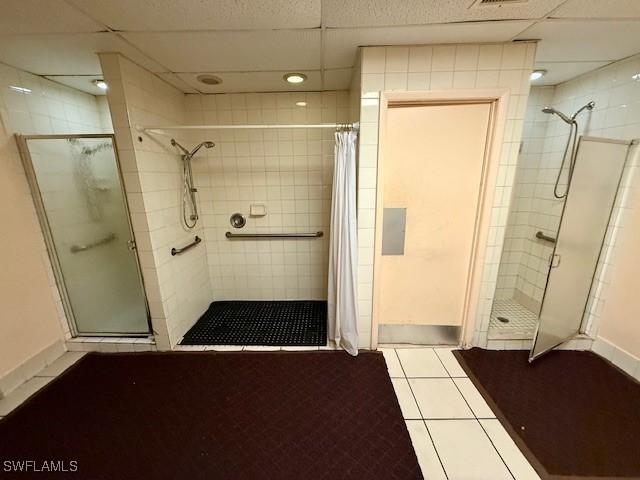 3760 Inverrary Dr Unit 1W, Lauderhill, FL 33319 - full bathroom with a shower stall, baseboards, tile patterned flooring, and a drop ceiling