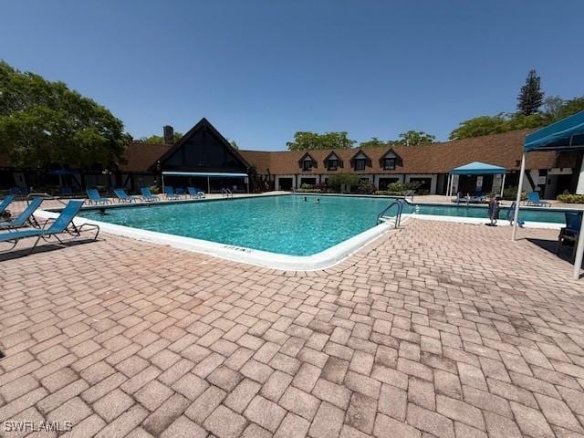 3760 Inverrary Dr Unit 1W, Lauderhill, FL 33319 - community pool featuring a patio