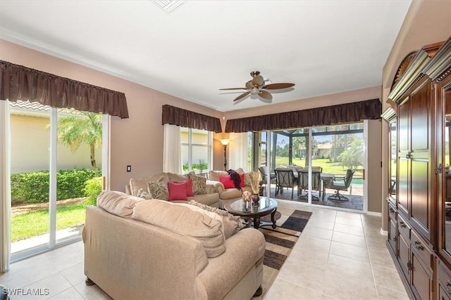 9327 Trieste Dr, Fort Myers, FL 33913 - living area featuring light tile patterned floors, a ceiling fan, and plenty of natural light