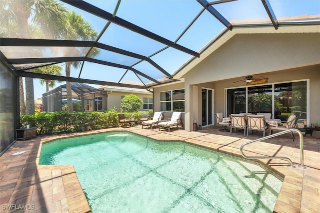 9327 Trieste Dr, Fort Myers, FL 33913 - swimming pool featuring a patio area, ceiling fan, an outdoor hangout area, and glass enclosure