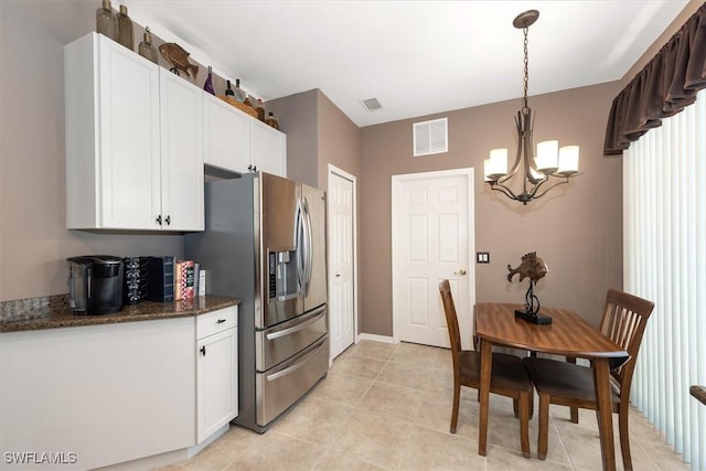 9327 Trieste Dr, Fort Myers, FL 33913 - kitchen featuring stainless steel fridge with ice dispenser, a chandelier, white cabinetry, dark stone countertops, and light tile patterned floors