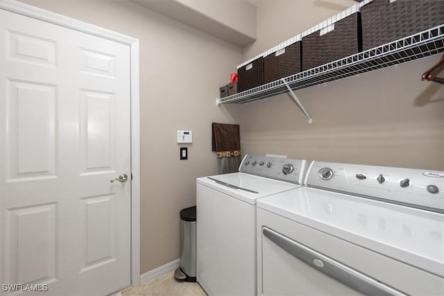 9327 Trieste Dr, Fort Myers, FL 33913 - washroom featuring washer and clothes dryer, baseboards, and light tile patterned flooring