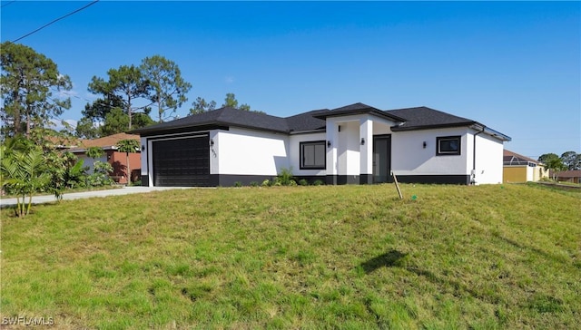 2933 20th St SW, Lehigh Acres, FL 33976 - view of front facade with stucco siding, an attached garage, a front lawn, and driveway