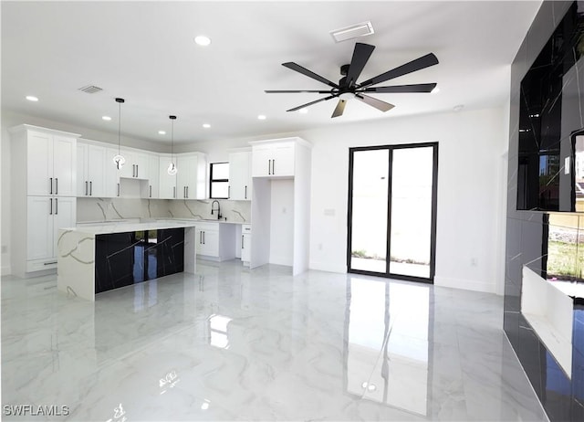 2933 20th St SW, Lehigh Acres, FL 33976 - kitchen featuring recessed lighting, ceiling fan, light marble finish floors, and white cabinets