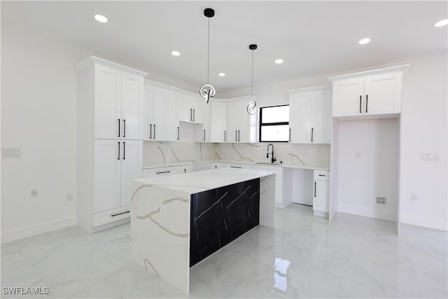 2933 20th St SW, Lehigh Acres, FL 33976 - kitchen featuring recessed lighting, light marble finish flooring, a kitchen island, and white cabinets