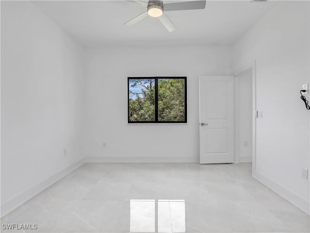 2933 20th St SW, Lehigh Acres, FL 33976 - empty room featuring ceiling fan and baseboards