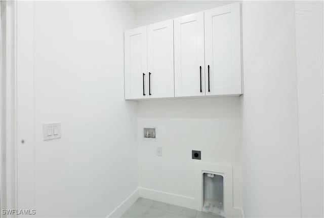 2933 20th St SW, Lehigh Acres, FL 33976 - washroom featuring cabinet space, hookup for an electric dryer, washer hookup, and light marble finish floors